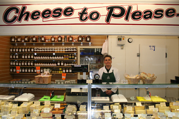 Behind the Cheese counter at Cheese to Please